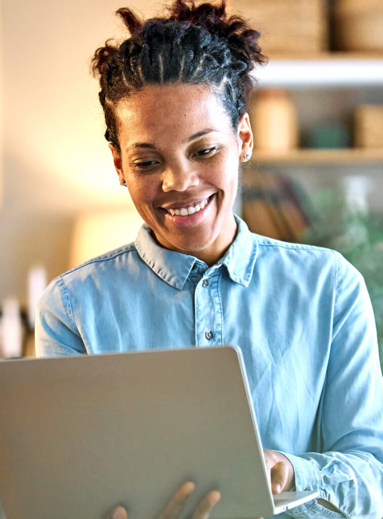 portrait of professional woman using laptop at home