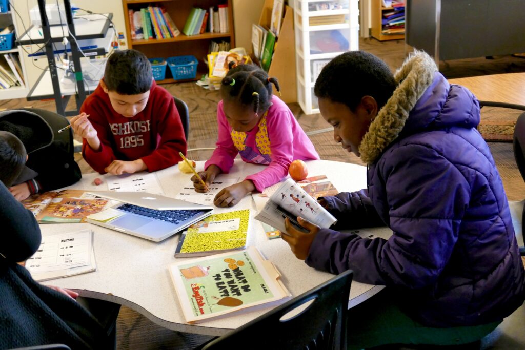 group of students working at table|NCSD logo|NCSD Case Study