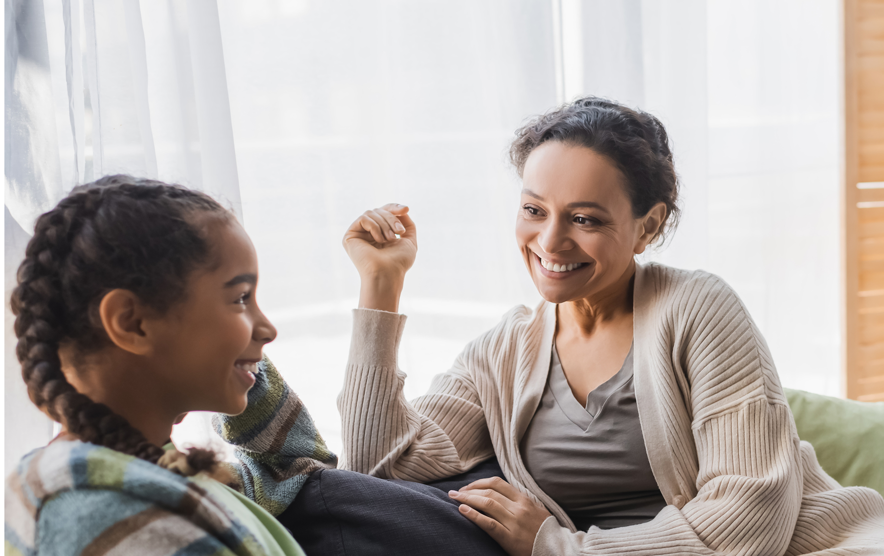 happy mother and daughter in conversation at home